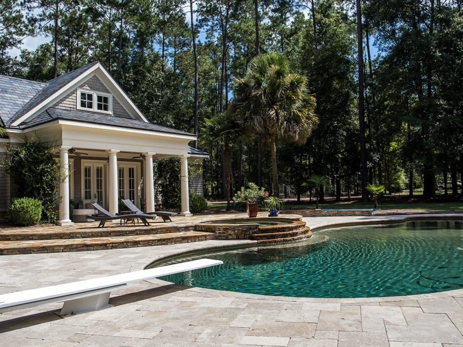 Large home with grotto style pool in backyard.