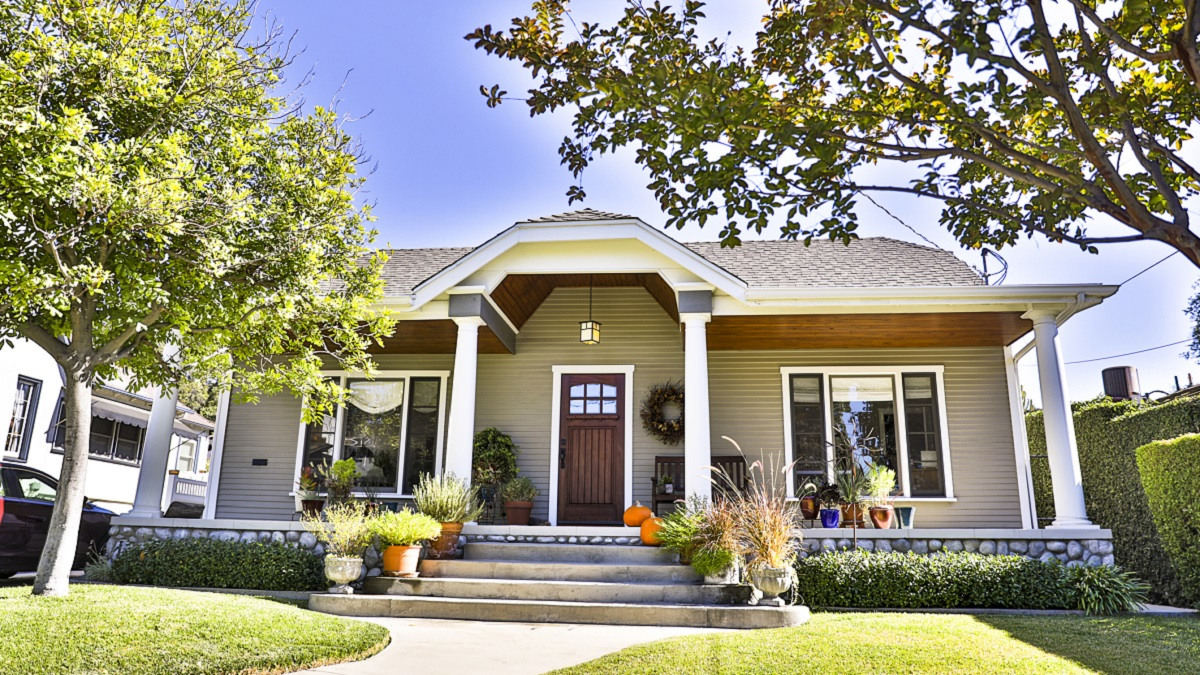 Home with potted plants on the front porch.