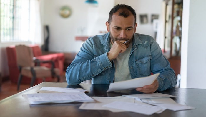 Man checking his finances and looking worried.