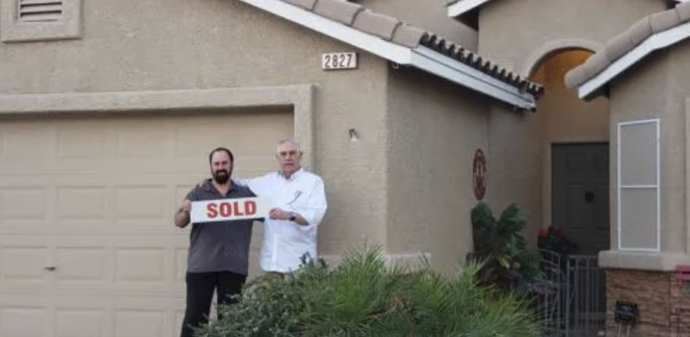 picture of Donald J. in front of a house